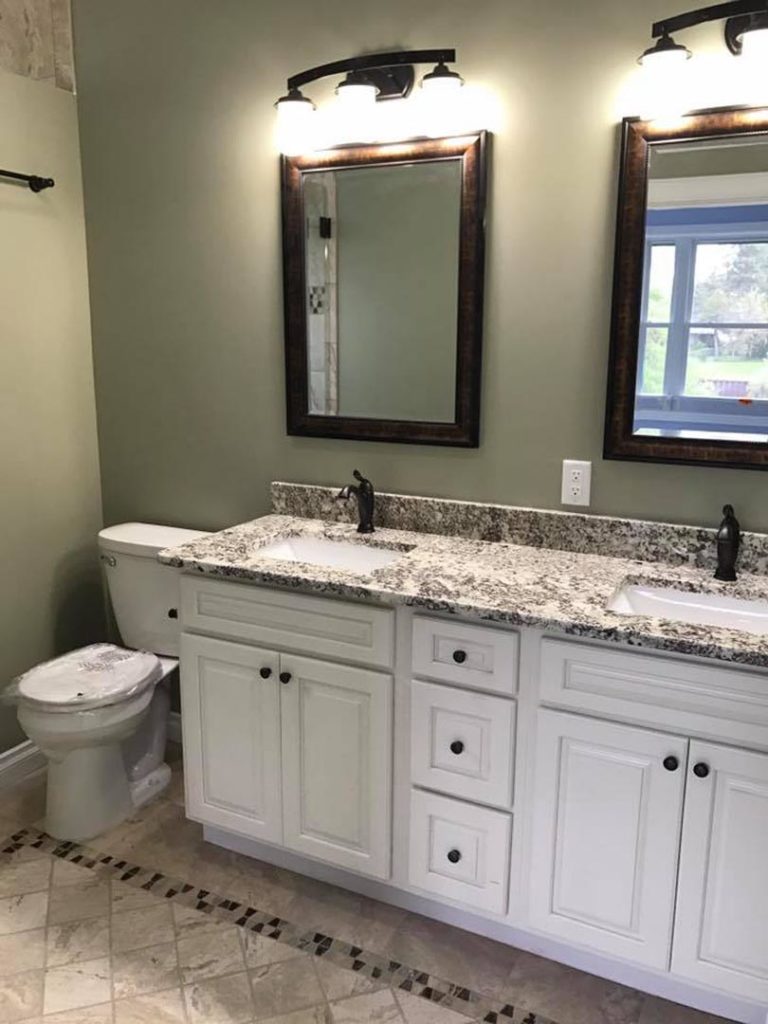 Here is a new built homes bathroom. The setting of the sinks, toilets and faucets are considered finish plumbing.